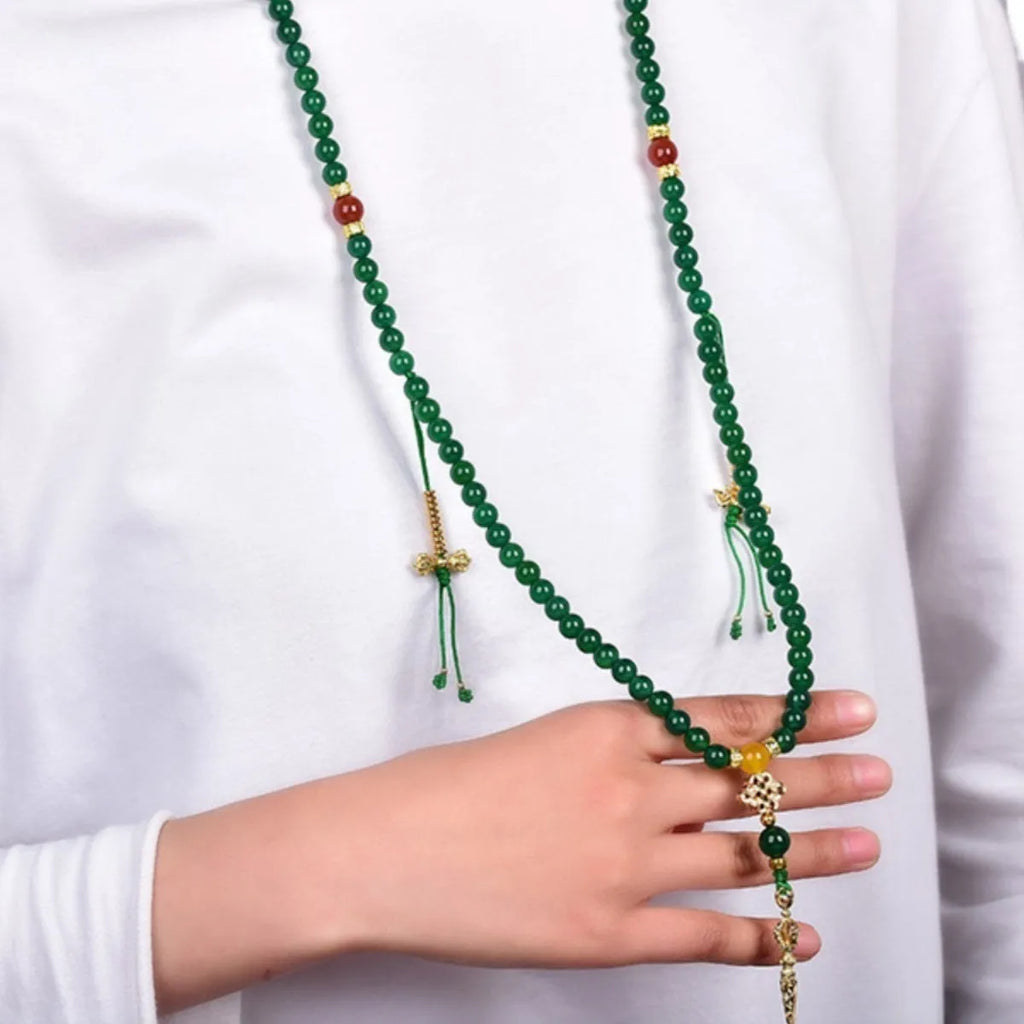 Close-up of a multi-circle green agate bracelet for men and women on a wrist.