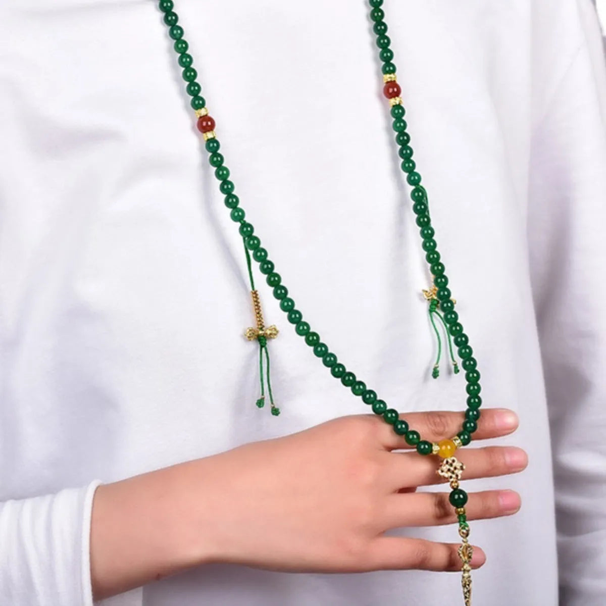 Close-up of a multi-circle green agate bracelet for men and women on a wrist.