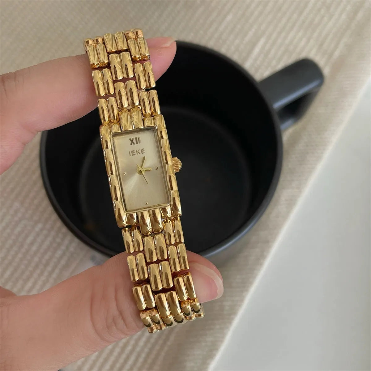 Women's mid-century inspired bracelet watch with 15mm dial and butterfly clasp in silver and gold colour options
