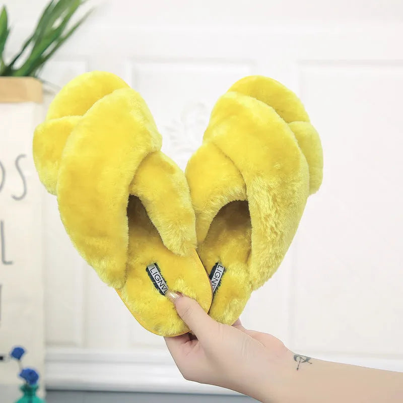 Women's black cross open-toe fur slippers showing the patterned non-slip sole and strap design.