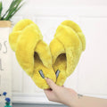 Women's black cross open-toe fur slippers showing the patterned non-slip sole and strap design.