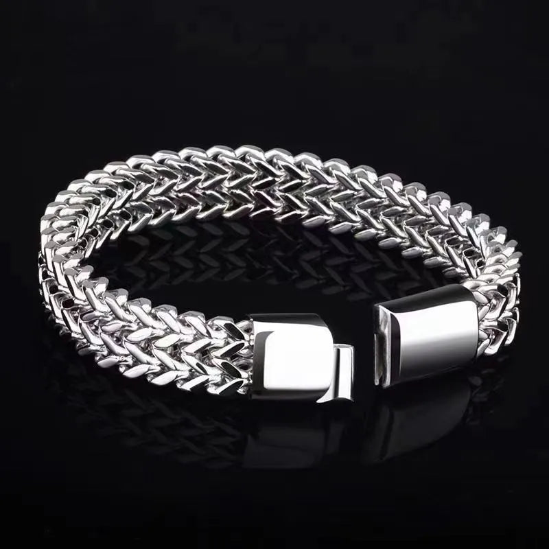 Silver titanium steel men's bracelet with geometric pattern on front and back of links.