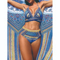Women's blue high waist bandage bikini set with smock, bra, and briefs on a neutral background.