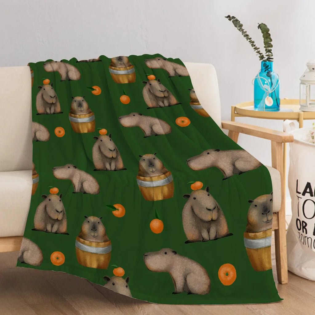 Flannel orange and capybara pattern soft fluffy multifunctional printed blanket on sofa