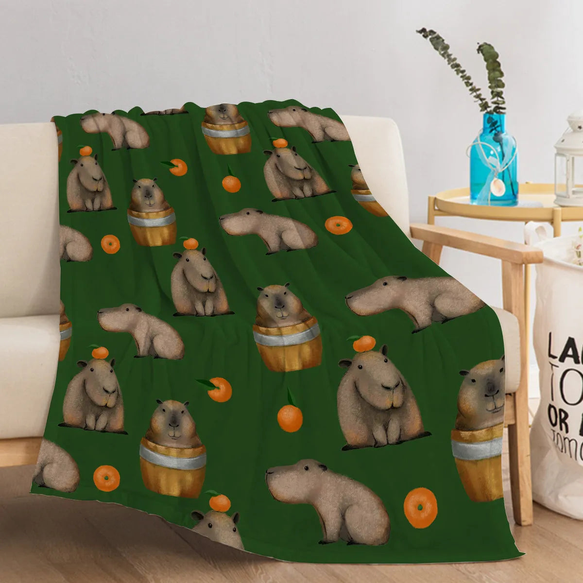 Flannel orange and capybara pattern soft fluffy multifunctional printed blanket on sofa