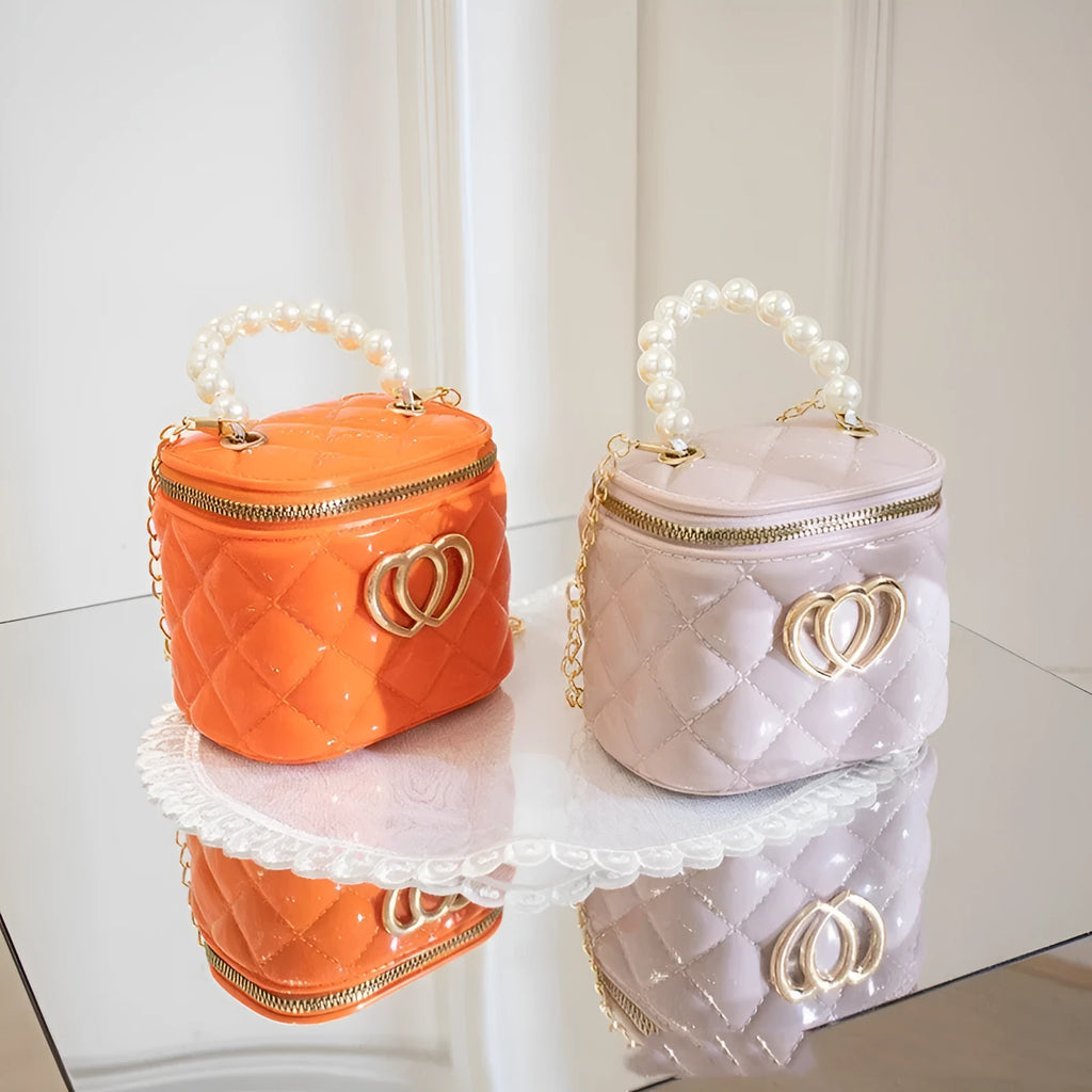 Women's PVC bucket handbag with heart pattern in various colours including red, black, and yellow