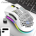 Hollow-out wireless gaming mouse with glowing light, shown in cyan colour on a desk.