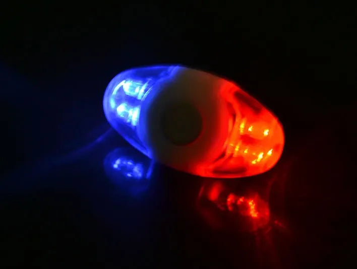 Red and blue LED bicycle tail light with adjustable mounting base.