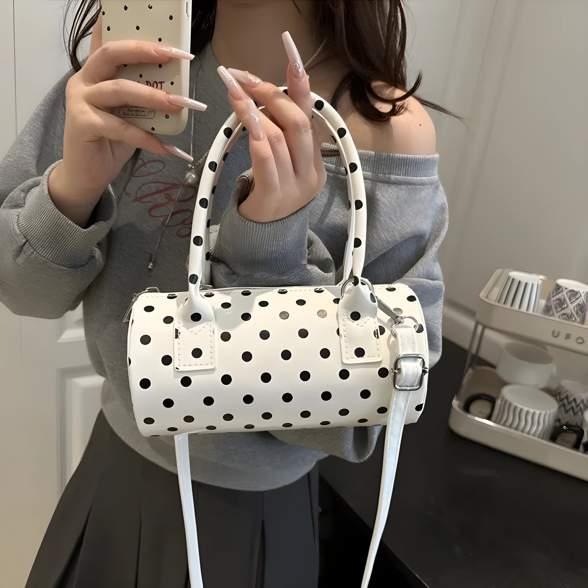 Korean-style cylindrical tote pillow bag in PU leather with stitched seams, black colour, single strap