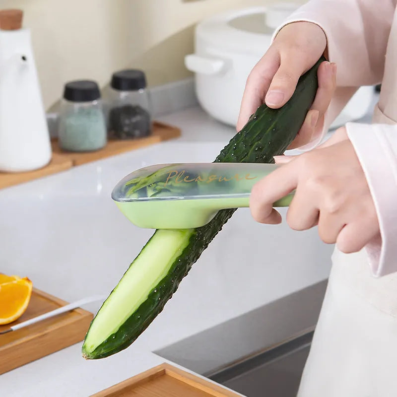 Dark green vegetable peeler with storage tube, showing stainless steel blade and non-slip handle.