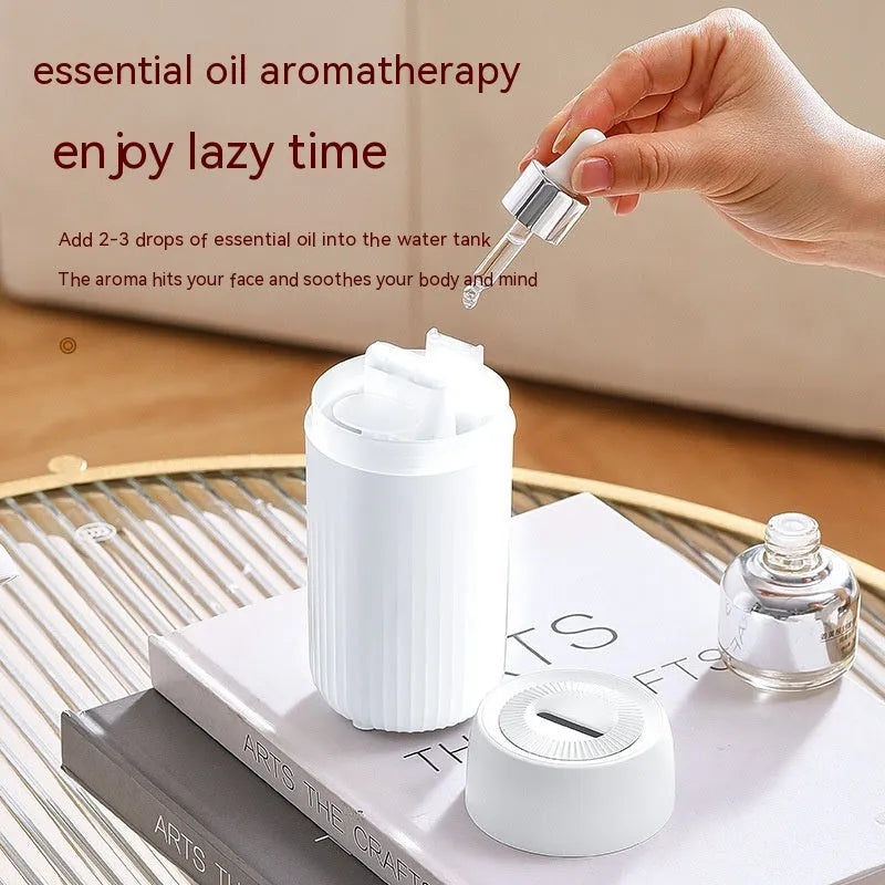 Black car aroma diffuser with flame simulation effect showing automatic sprayer functionality