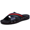 Men's white cowhide leather flip flops with a non-slip sole on a sandy beach.