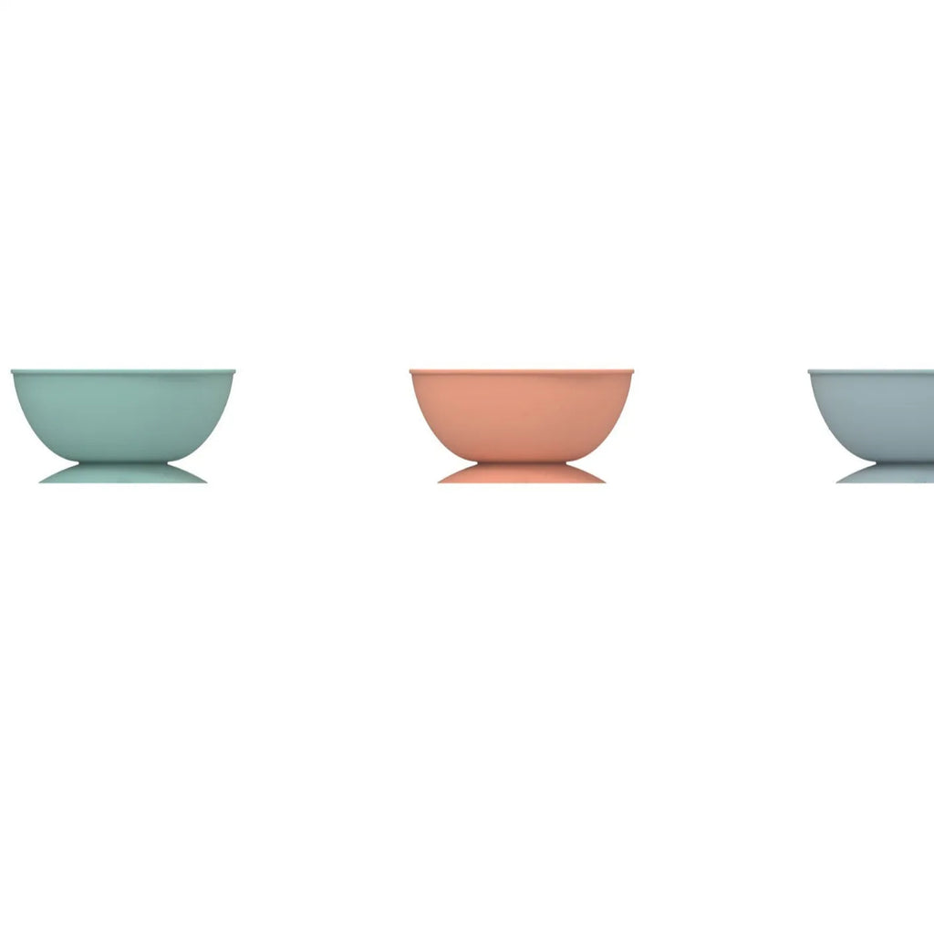 Cyan silicone dog licking mat slow feeder bowl with textured surface and suction cup base.