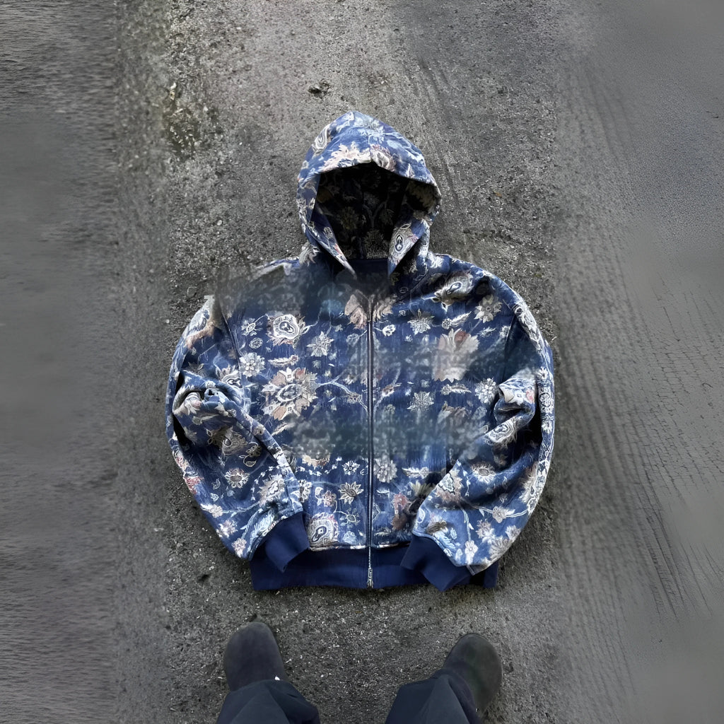 Blue loose fit men's hooded zip coat with front zip and long sleeves on a hanger.