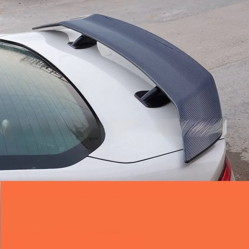 Universal punch-free car tail wing spoiler in ABS plastic shown in carbon pattern finish