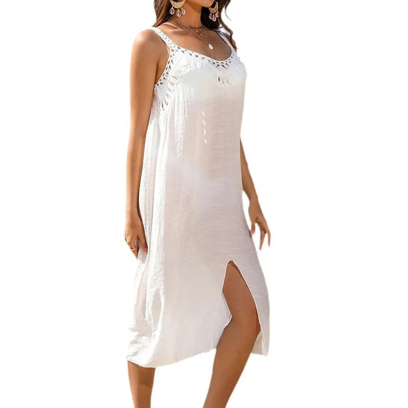 White sleeveless crochet beach dress with hollow weaving and a side slit.