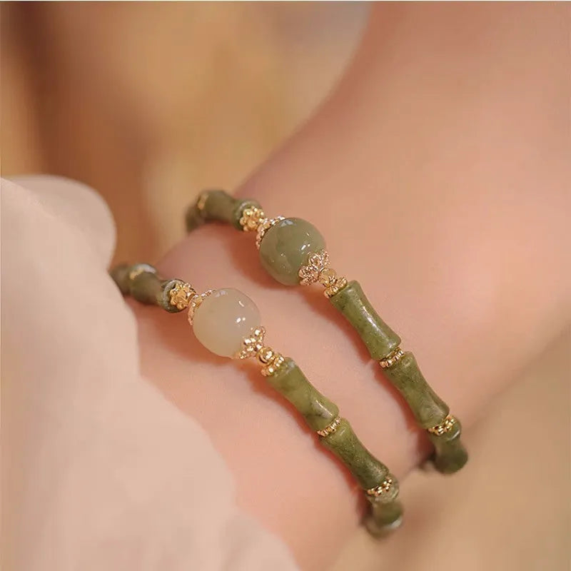 Women's simple geometric Hetian jade bracelet in dark green and light colour on a white background.