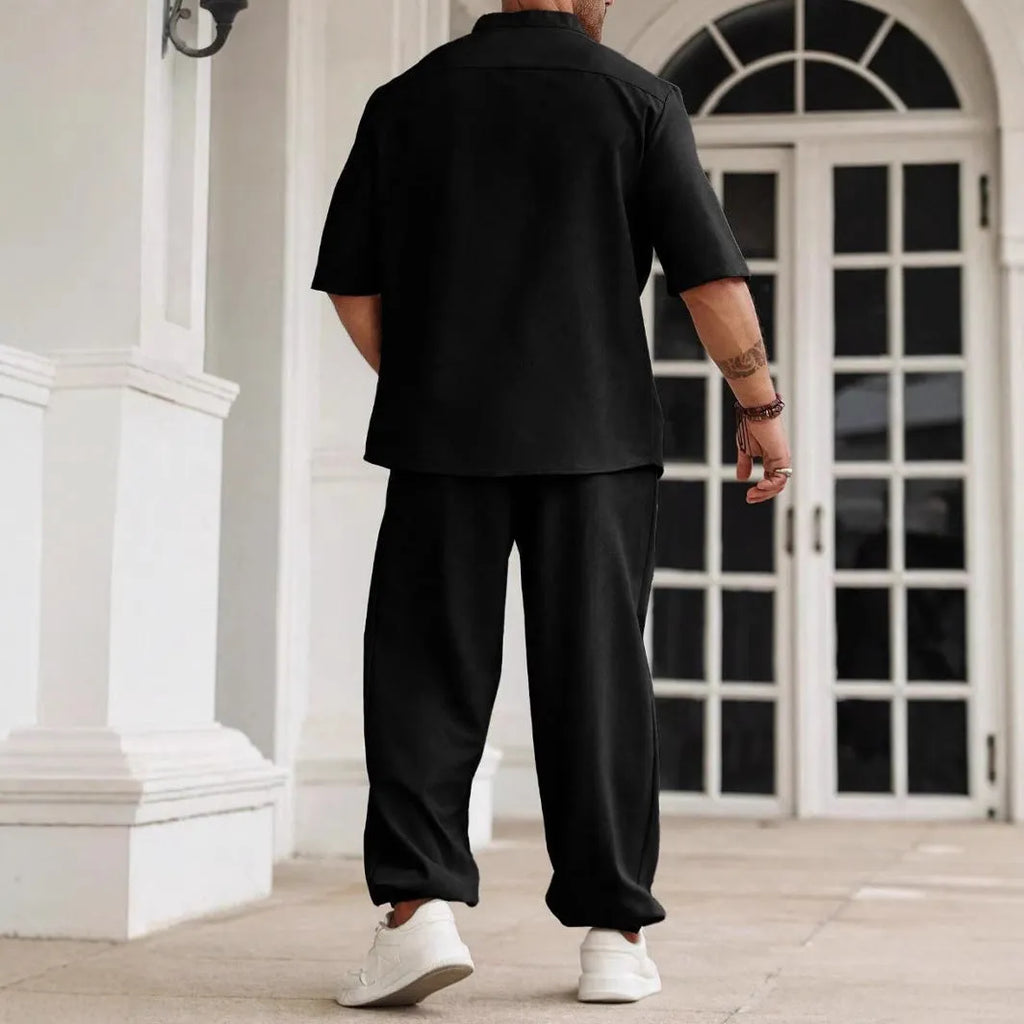 Men's apricot coloured cotton linen short-sleeved shirt jacket and trouser casual set laid flat.