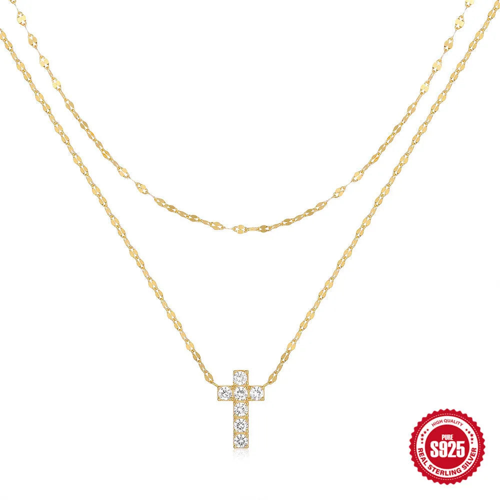 Sterling silver double layer twin diamond cross necklace on a clavicle chain, shown in gold tone.