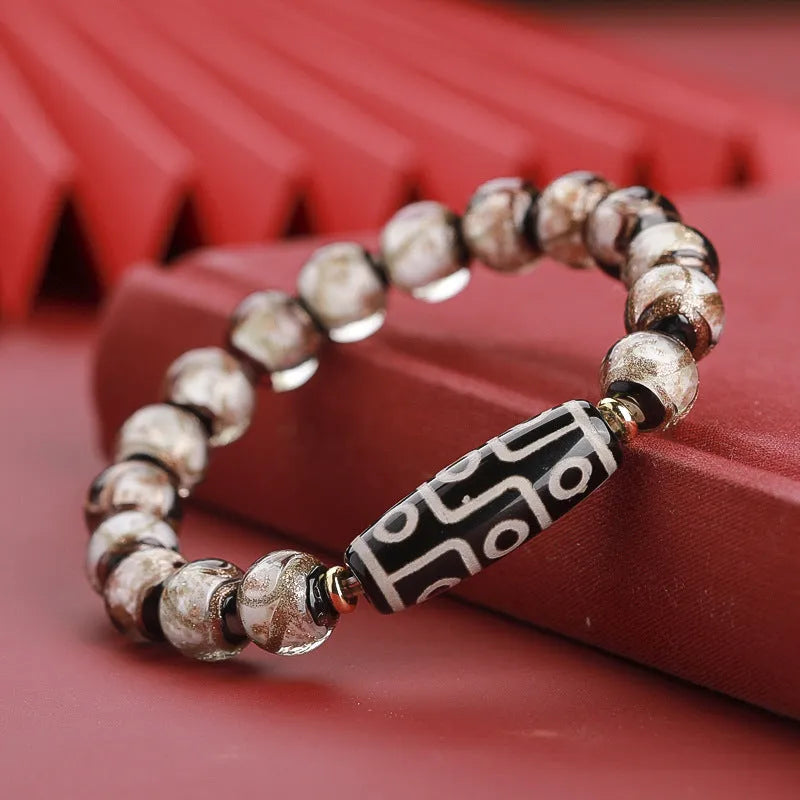 Close-up of a colourful handcrafted Chinese bracelet with snake lucky beads and auspicious patterns.