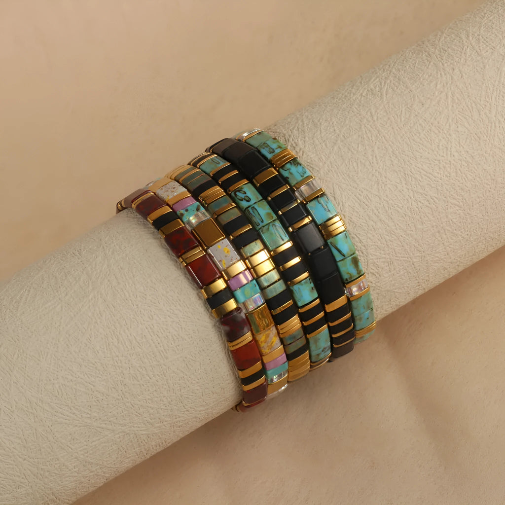 Geometric glass bead bracelet with pull beads design on a wrist, shown in milky white colour.