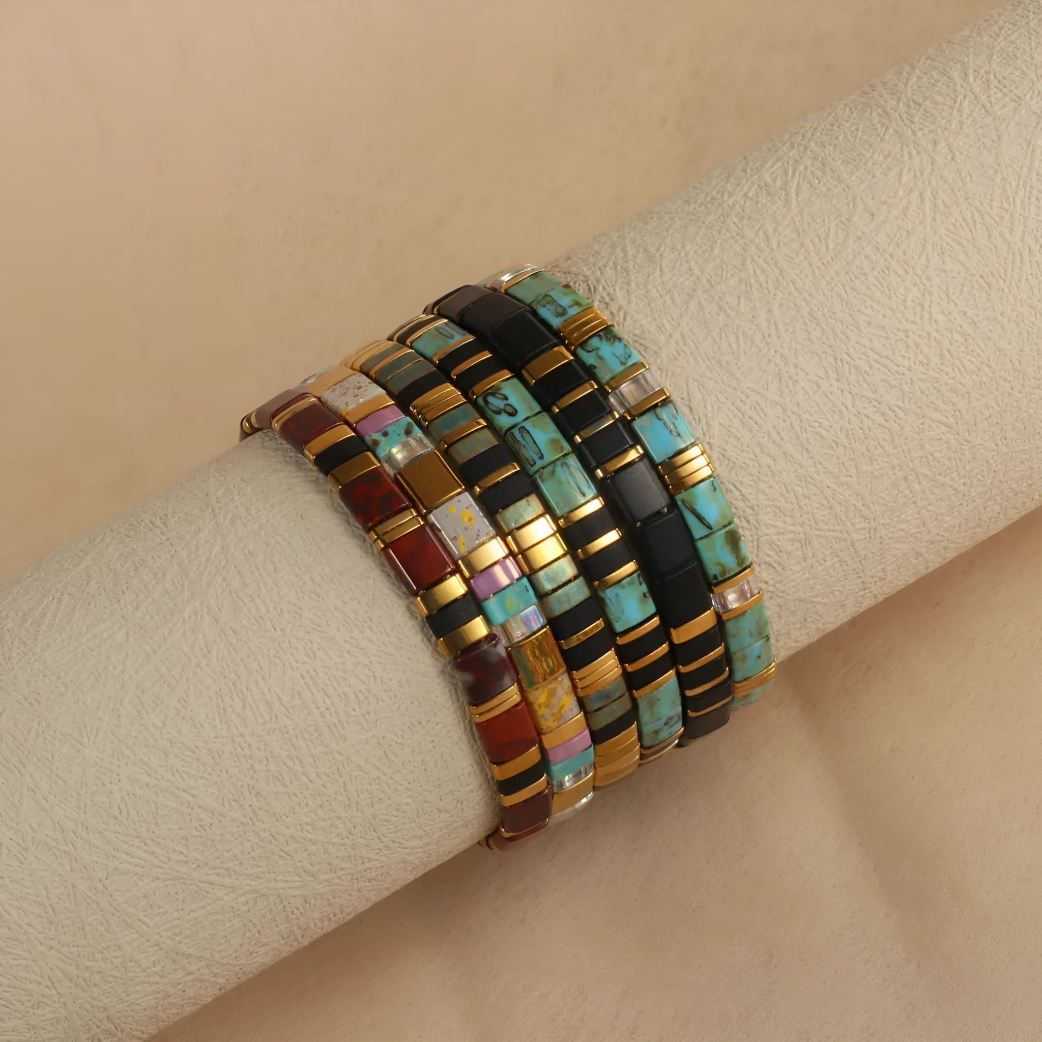 Geometric glass bead bracelet with pull beads design on a wrist, shown in milky white colour.