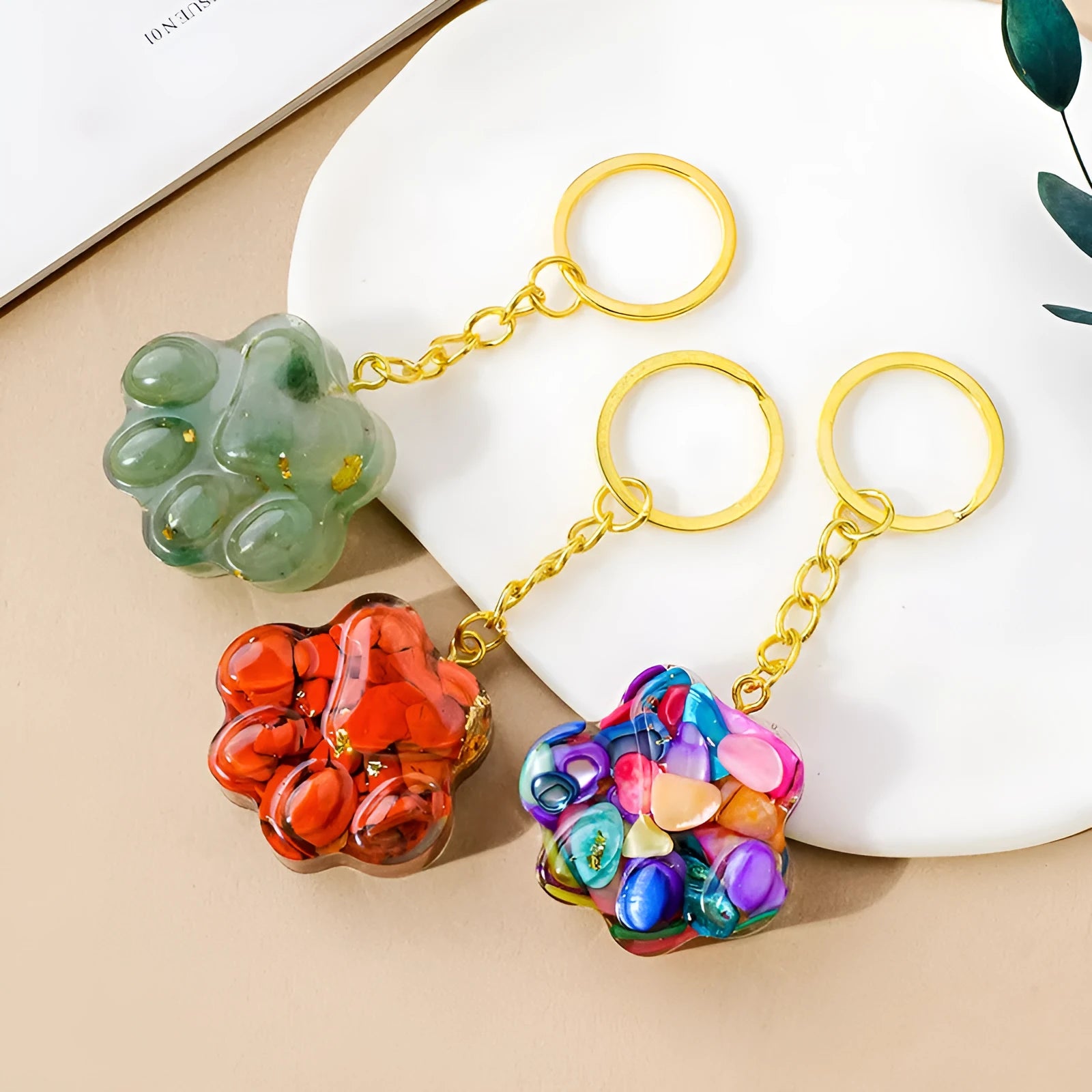 Natural crystal cat's paw keychain pendant in various gemstone colours including pink, red, blue and green crystals