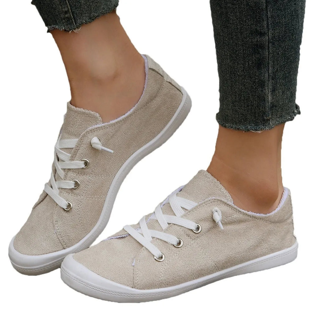 Women's creamy white low-top casual sneakers with fabric upper and rubber outsole on a neutral background