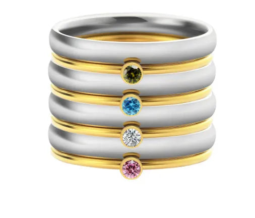 Geometric titanium steel ring with engraved December birthstone colour design on a white background.
