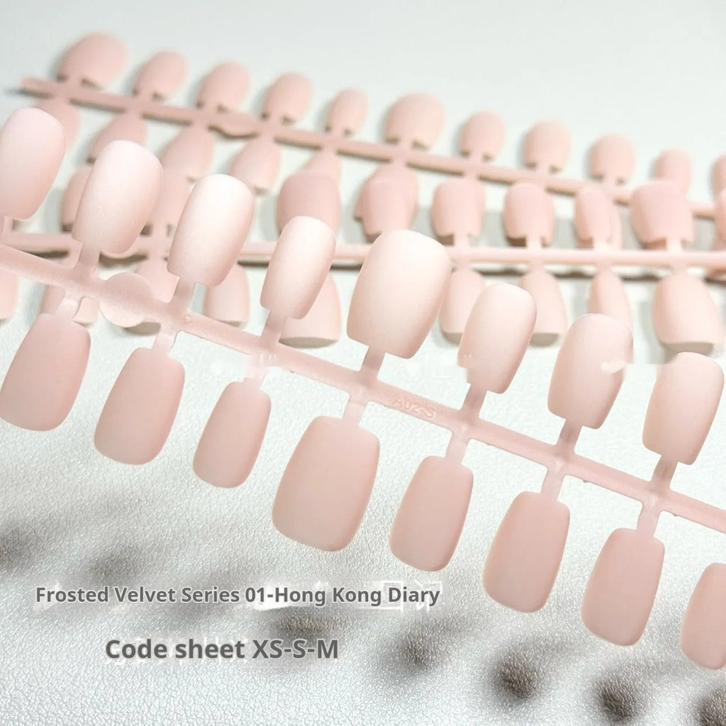 Frosted Velvet Cat's Eye false nails showing Aurora armour design on short ladder shaped PVC nails.