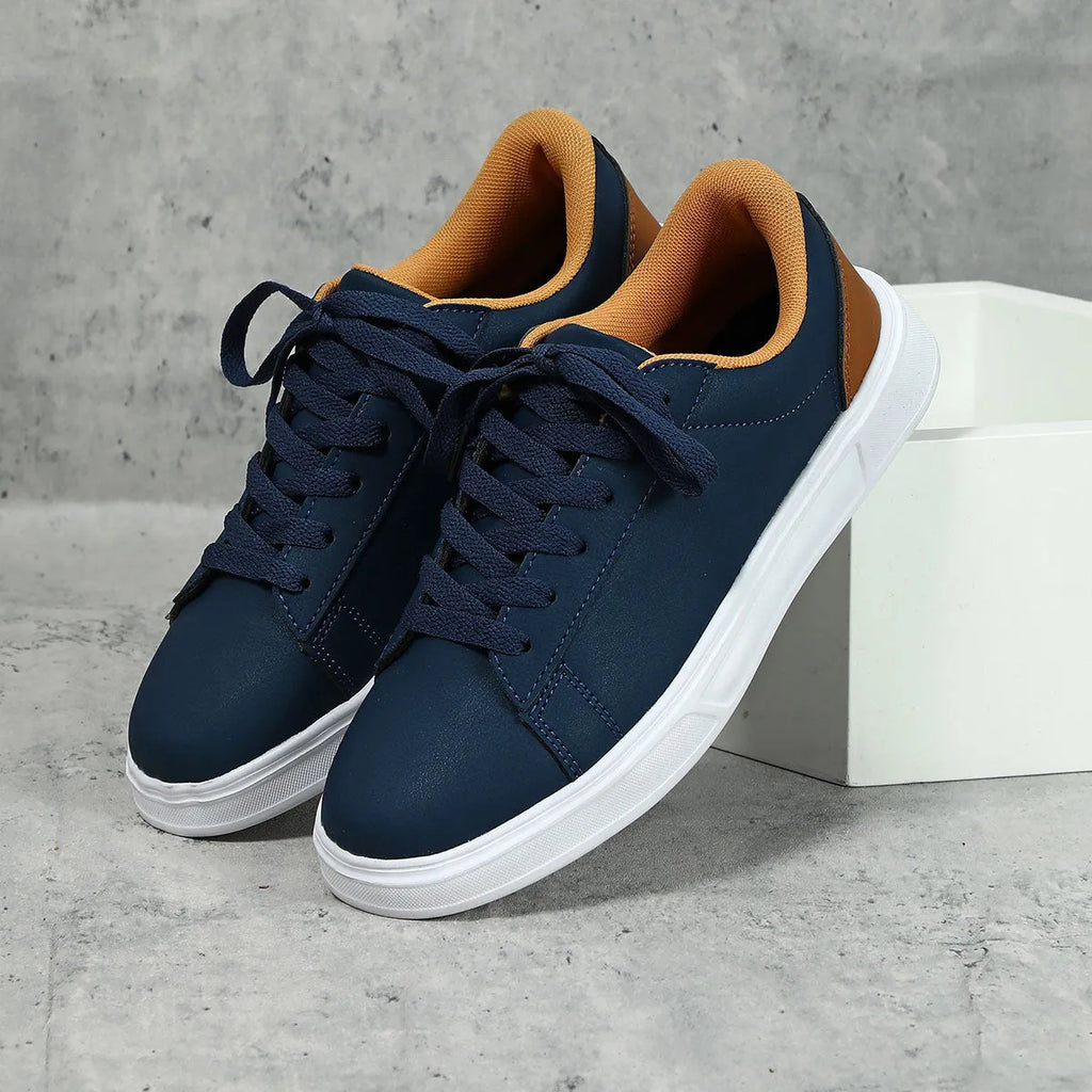 Beige brown casual platform sneakers with a cross strap and round toe on a rubber sole.