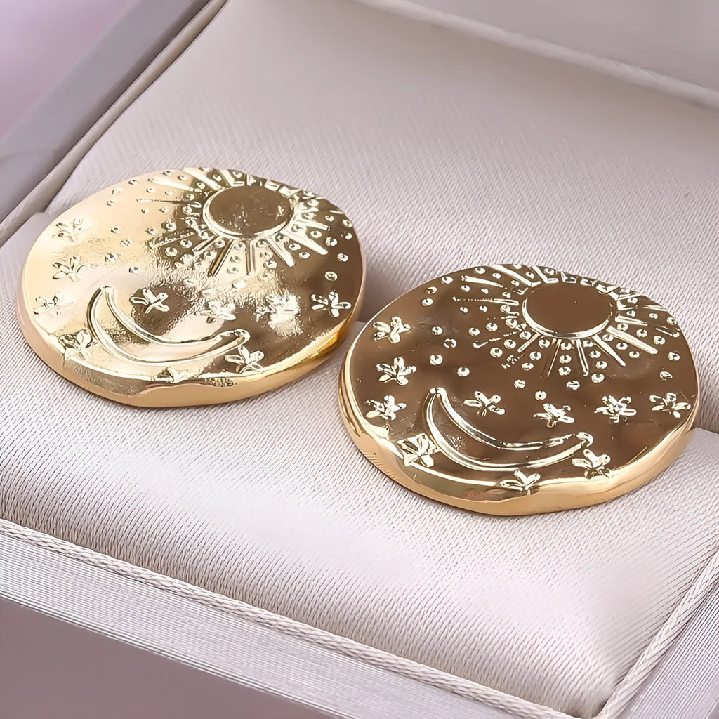 A pair of geometric shell design stud earrings in stainless steel, shown in gold and silver colour options.