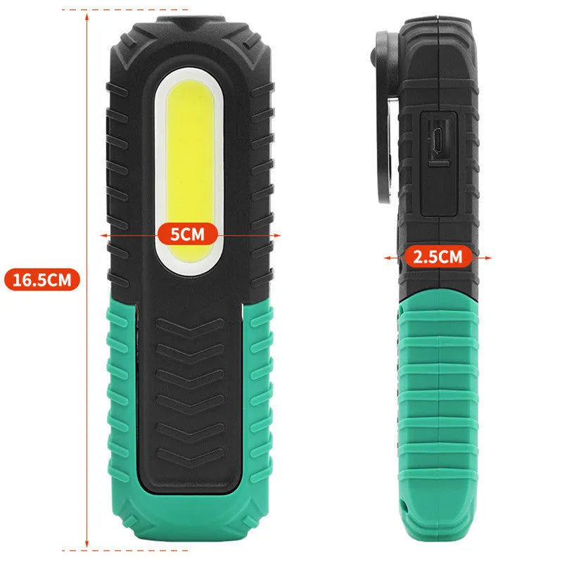 Black and green USB rechargeable automotive inspection work light on a workshop bench.