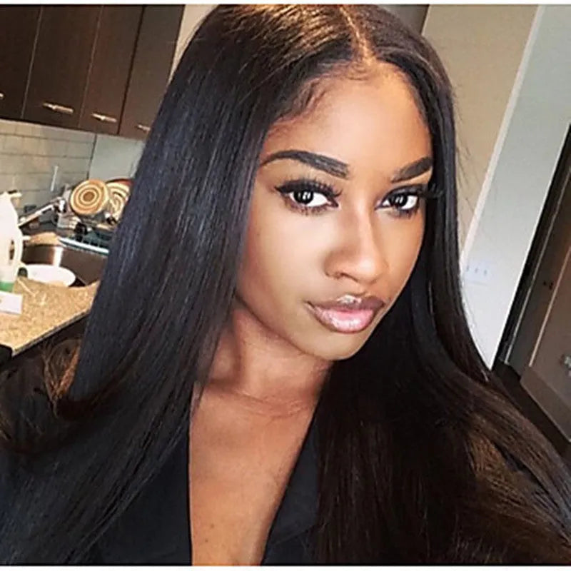 Long straight black synthetic wig with centre parting and fringe on a mannequin head.