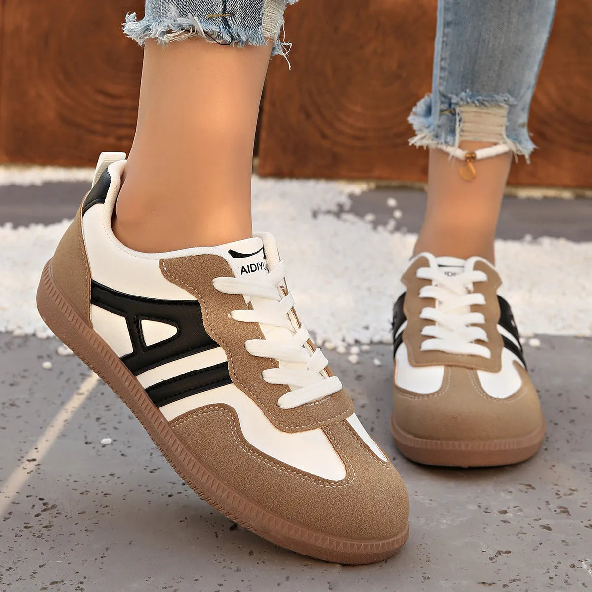 Women's retro colour matching lace-up jogging shoes in black with cross strap and low platform heel.