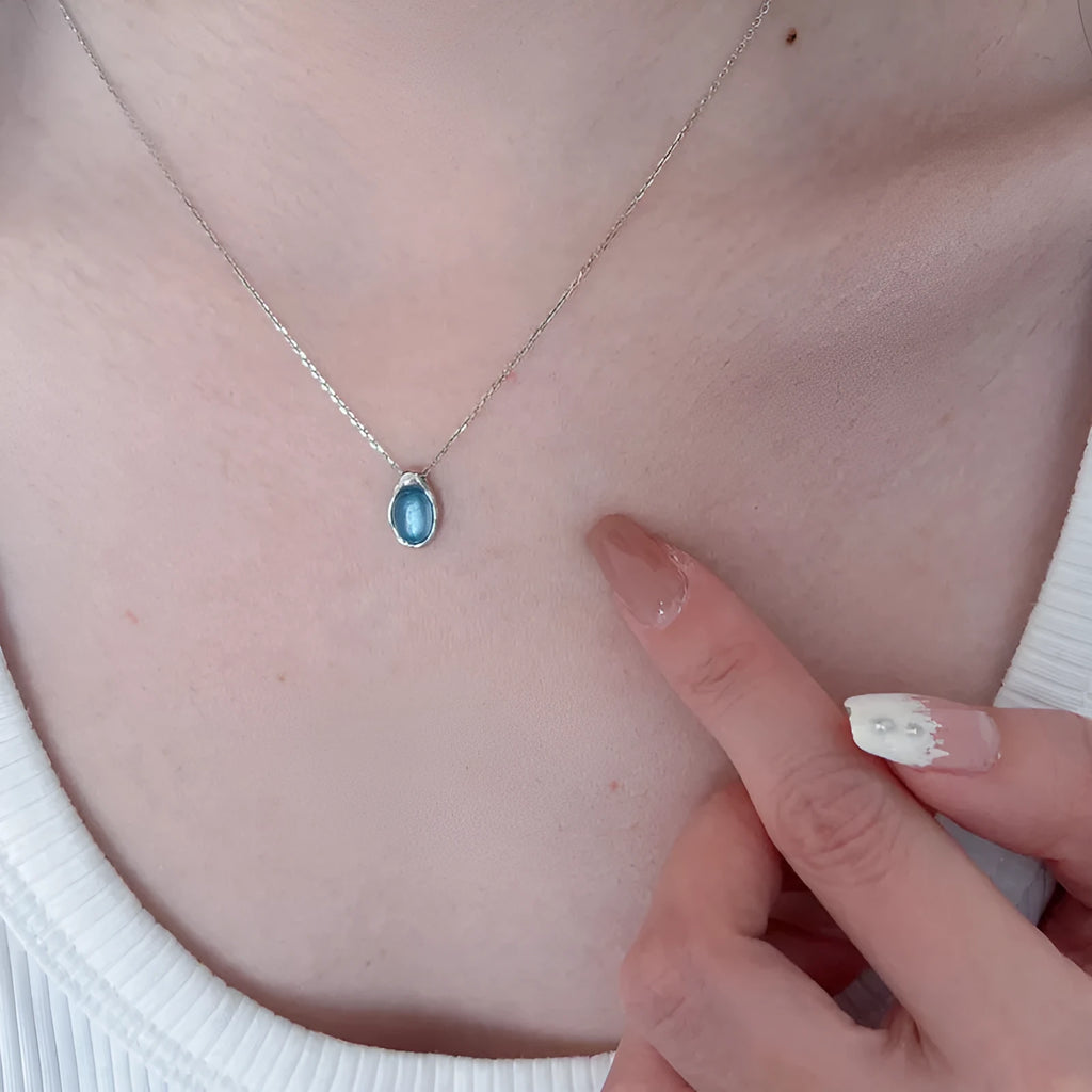 Navy blue water drop pendant necklace with adjustable cross chain in platinum colour