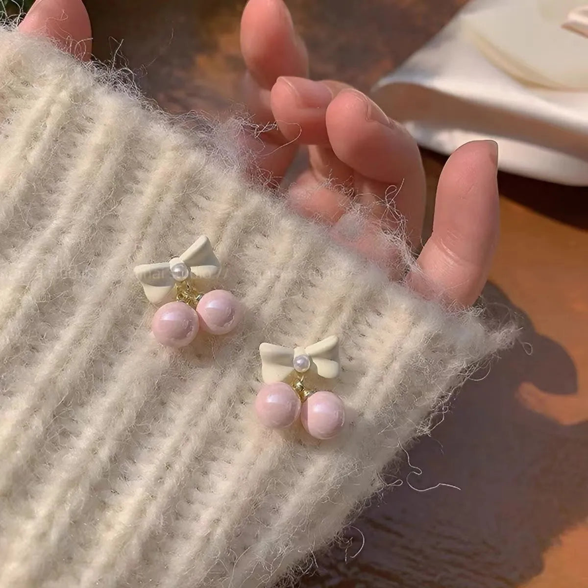 Pink heart pearl bow earrings on alloy with electroplated finish, silver needle style
