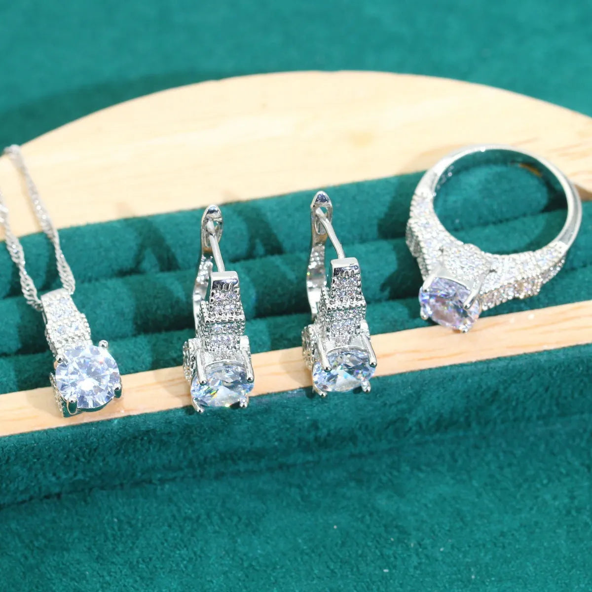 Four-piece bridal jewellery set showing necklace, bracelet, earrings, and ring with water wave chain
