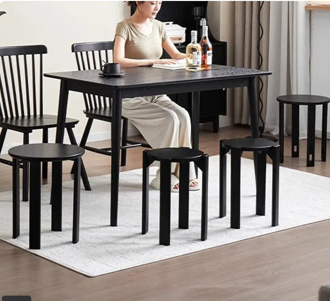 Stackable round metal dining stool in a modern style, shown in a cream white finish.