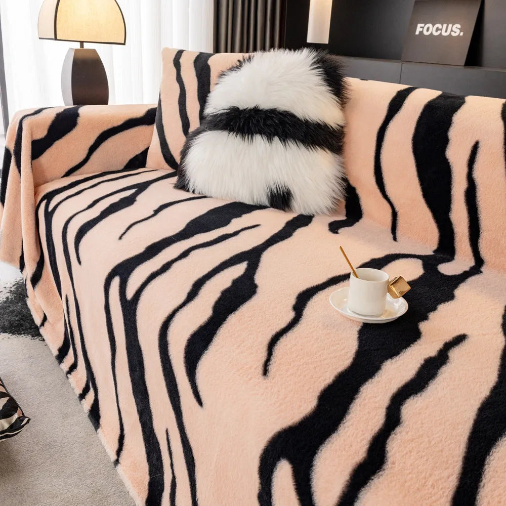 Zebra pattern flannel sofa cover with non-slip backing shown in a caramel colour.