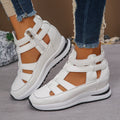Women's black platform sandals with hollow-out design and Velcro strap.