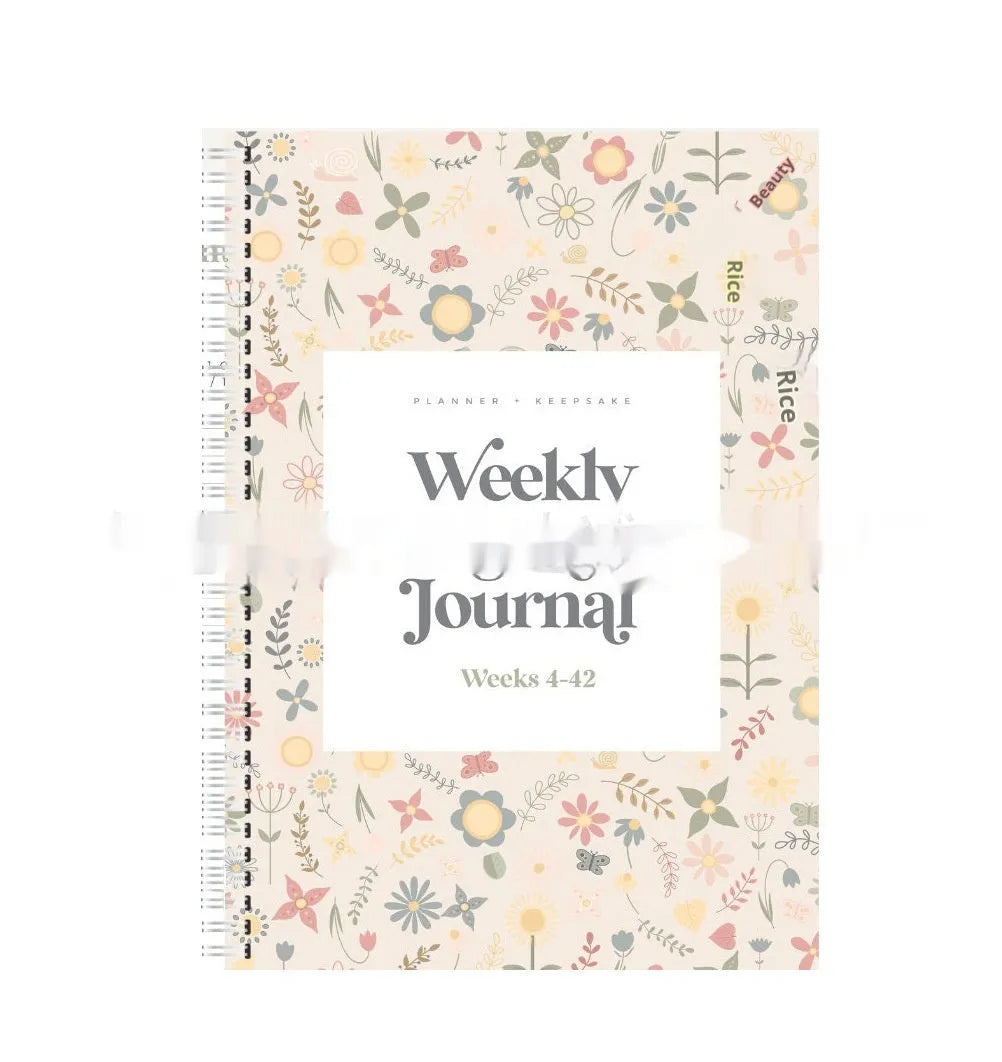A5 pregnancy diary notebook open to weekly pregnancy tracking pages
