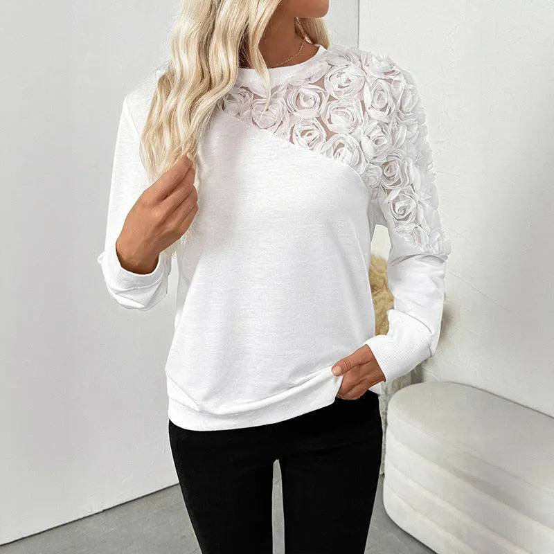 White women's long sleeve pullover top with floral pattern, loose fit.