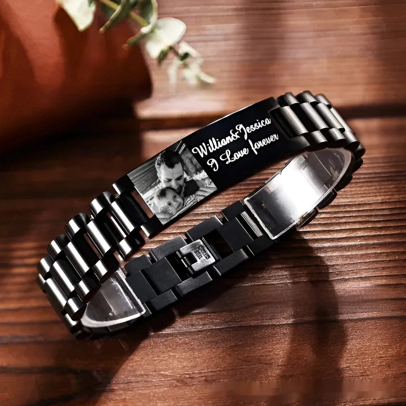 Men's stainless steel bracelet with curved heart piece featuring black electroplated lettering
