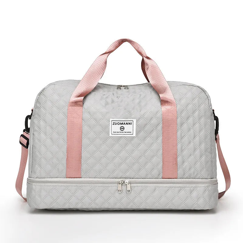 Large Oxford cloth travel bag in a solid colour with contrast stitching, shown with buggy and travel items.