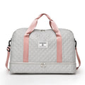 Large Oxford cloth travel bag in a solid colour with contrast stitching, shown with buggy and travel items.