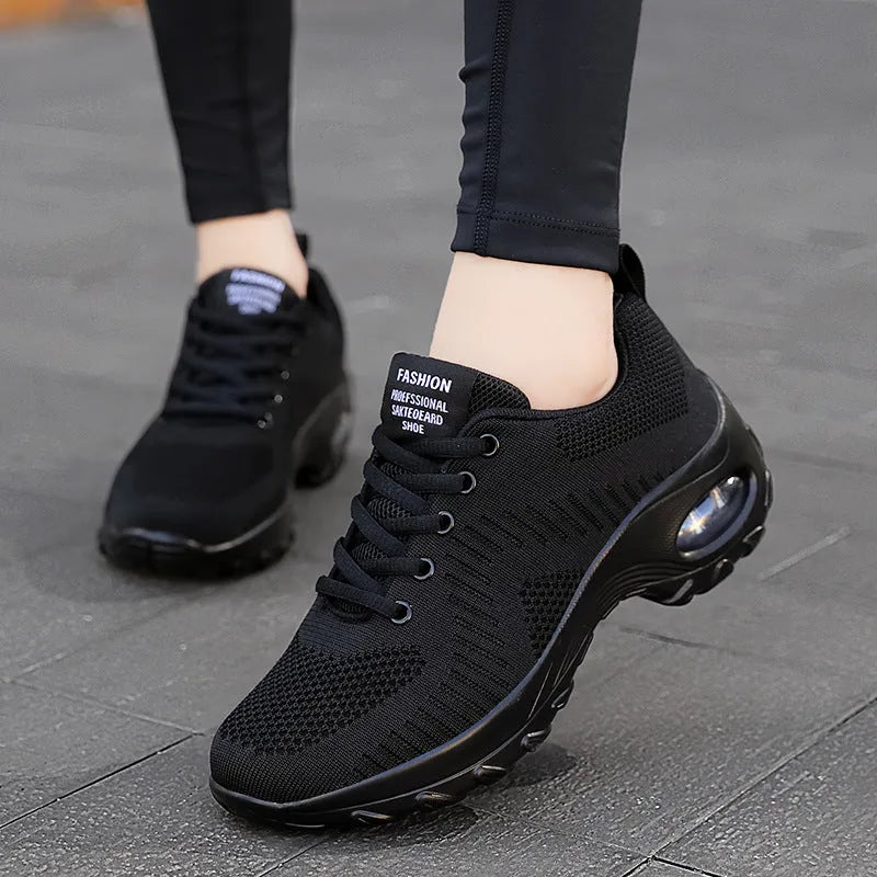 Women's black low top mesh sneakers with front laces and a round toe on a PU sole.