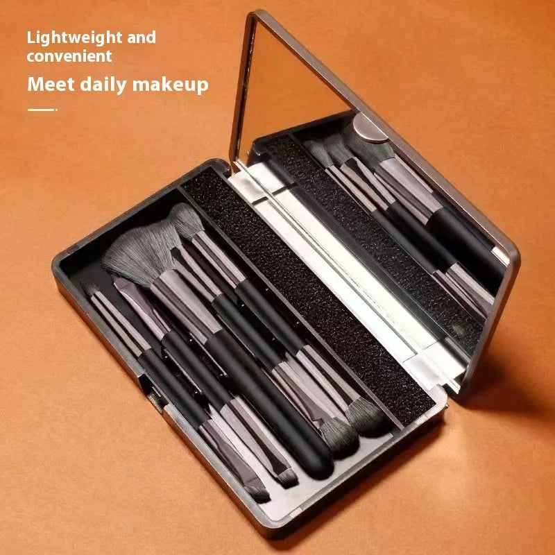 Silver and gold portable makeup brush sets with mirror case open showing eyeshadow brushes.