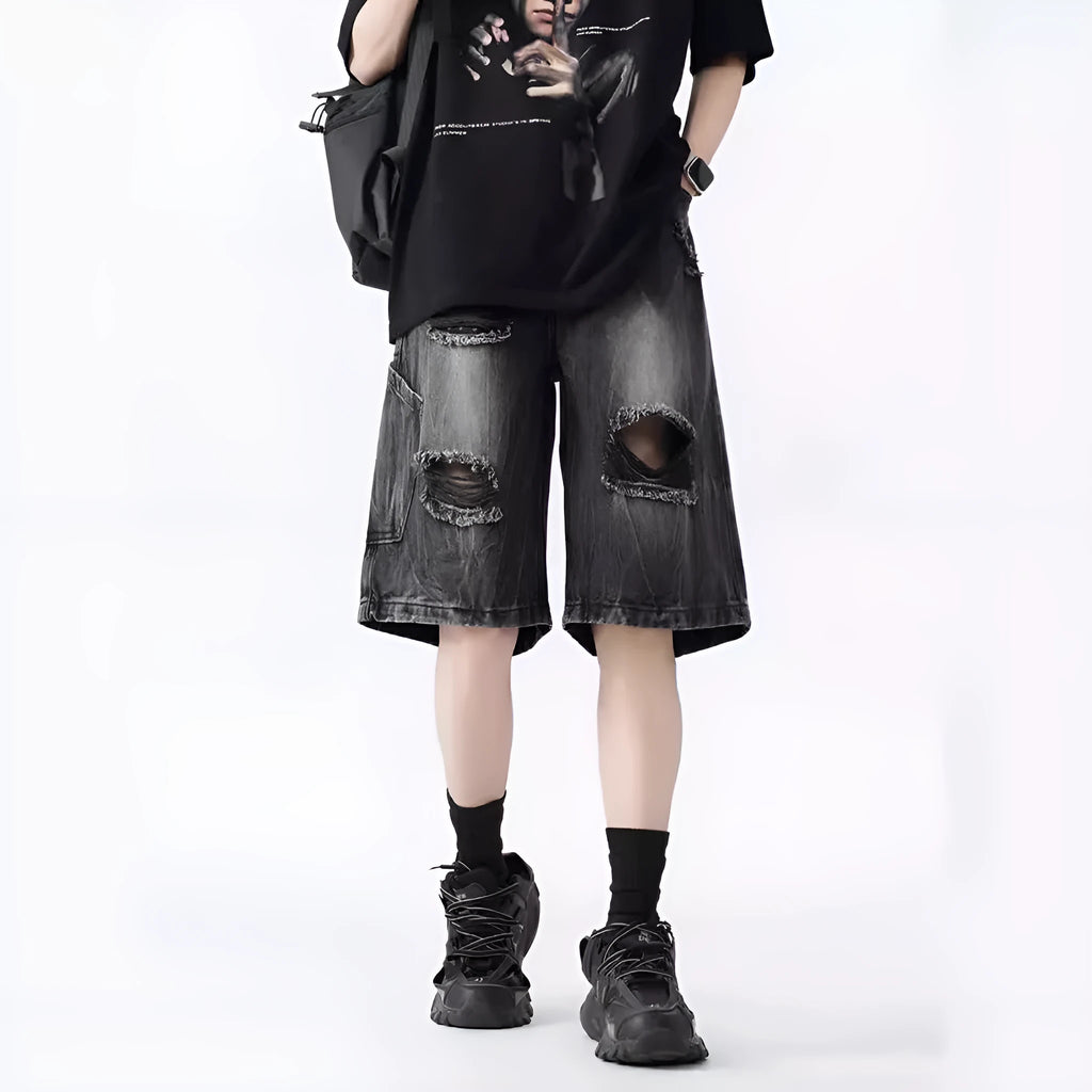 Women's distressed denim shorts with ripped detailing and washed vintage finish in loose retro fit