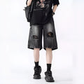 Women's distressed denim shorts with ripped detailing and washed vintage finish in loose retro fit